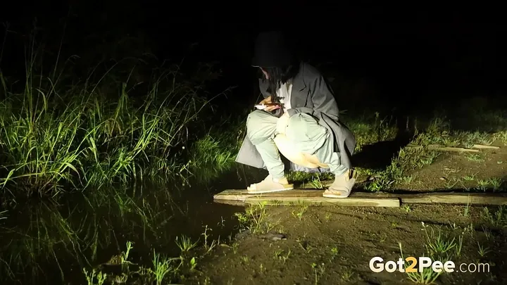 Night Lights Glow as She Squats for an Outdoor Piss